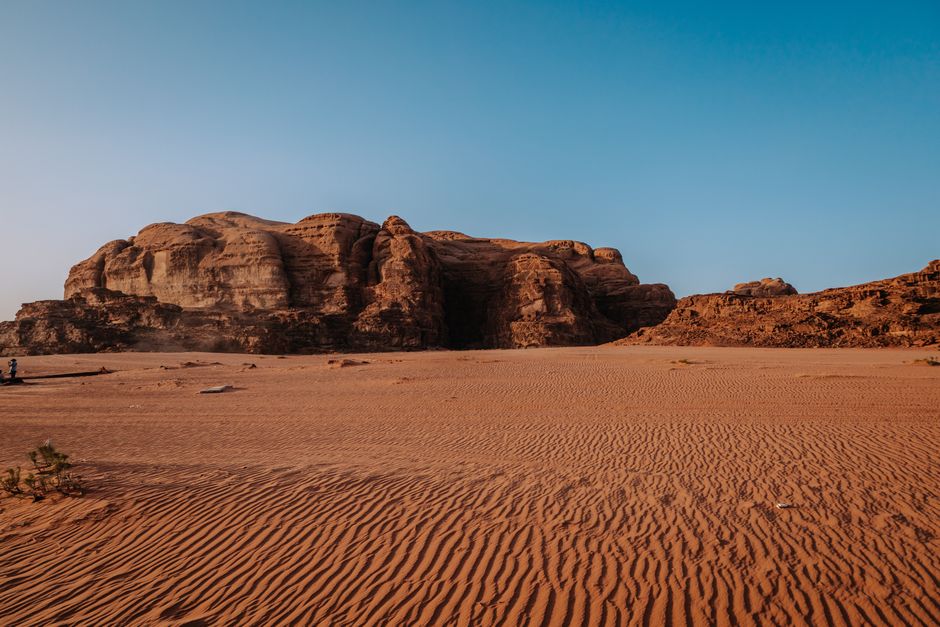 Sandstone cliffs and open sand in Wadi Rum, Jordan